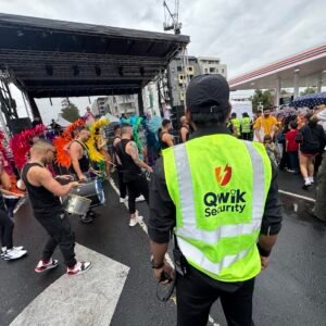 Qwik Security roaming guard in a high-visibility vest monitoring a street festival