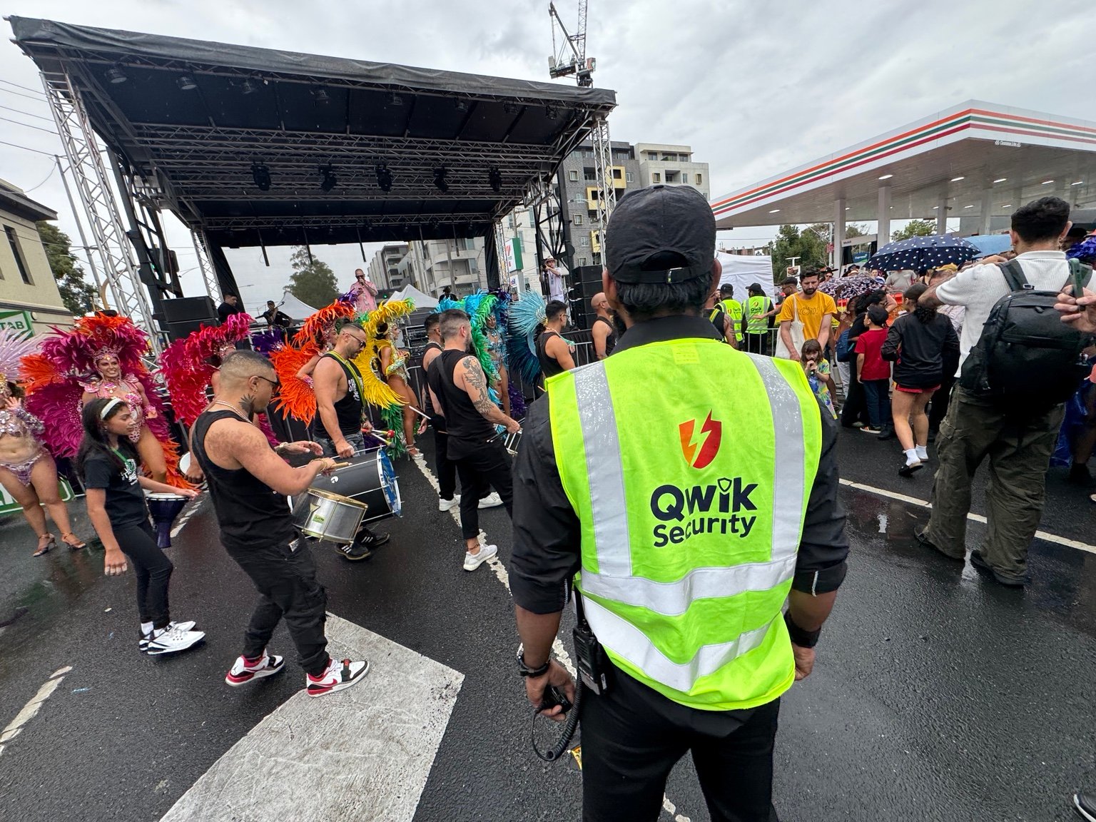 Qwik Security roaming guard in a high-visibility vest monitoring a street festival
