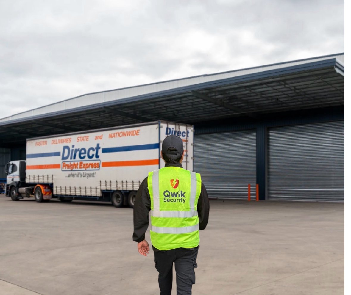 Qwik Security warehouse security guard outside loading bays with a Direct Freight Express truck visible