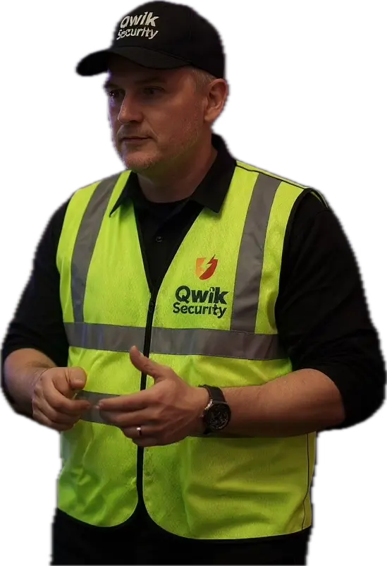 Qwik Security construction site guard wearing a high visibility vest