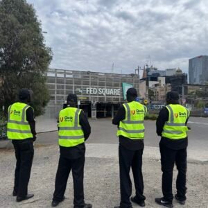Four Qwik Security event guards in high-visibility vests at Federation Square, Melbourne