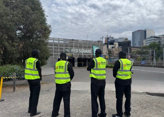 Four Qwik Security event guards in high-visibility vests at Federation Square, Melbourne