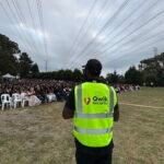 Qwik Security static guard in a high-visibility vest monitoring an outdoor event