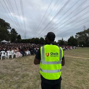 Qwik Security static guard in a high-visibility vest monitoring an outdoor event