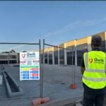 Qwik Security guard at the entrance to a fenced construction site
